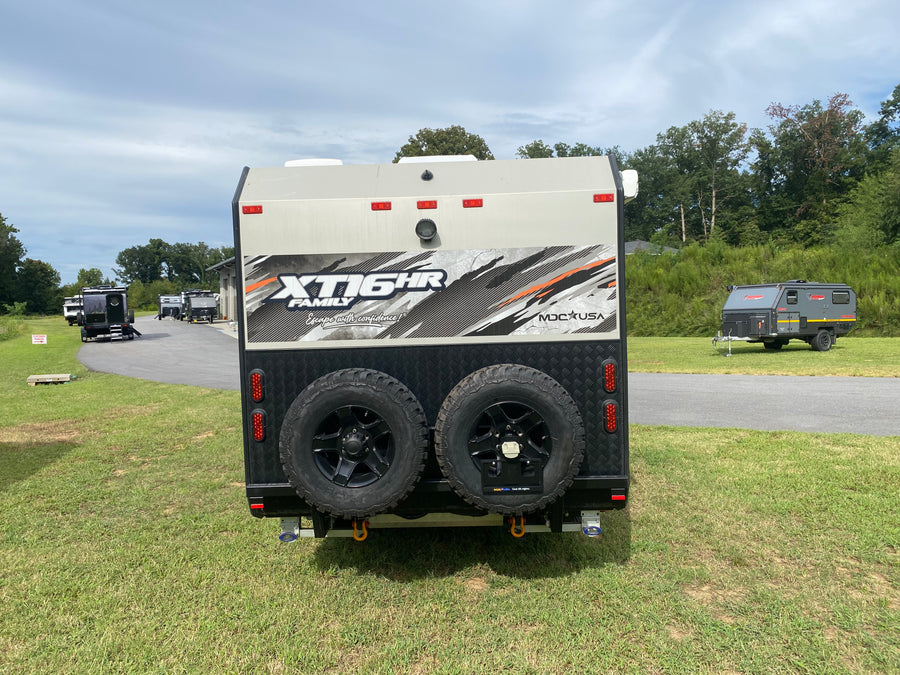 Rear view of an MDC XT16HR off-road trailer with dual spare tires and recovery points