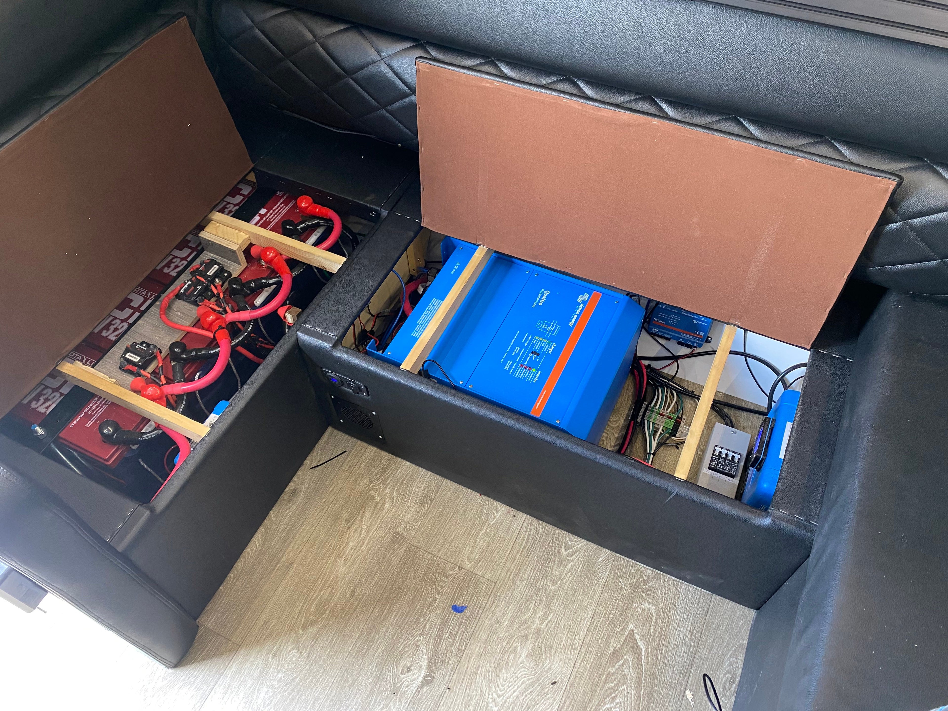 Storage compartment with batteries and wiring Black Series camper.