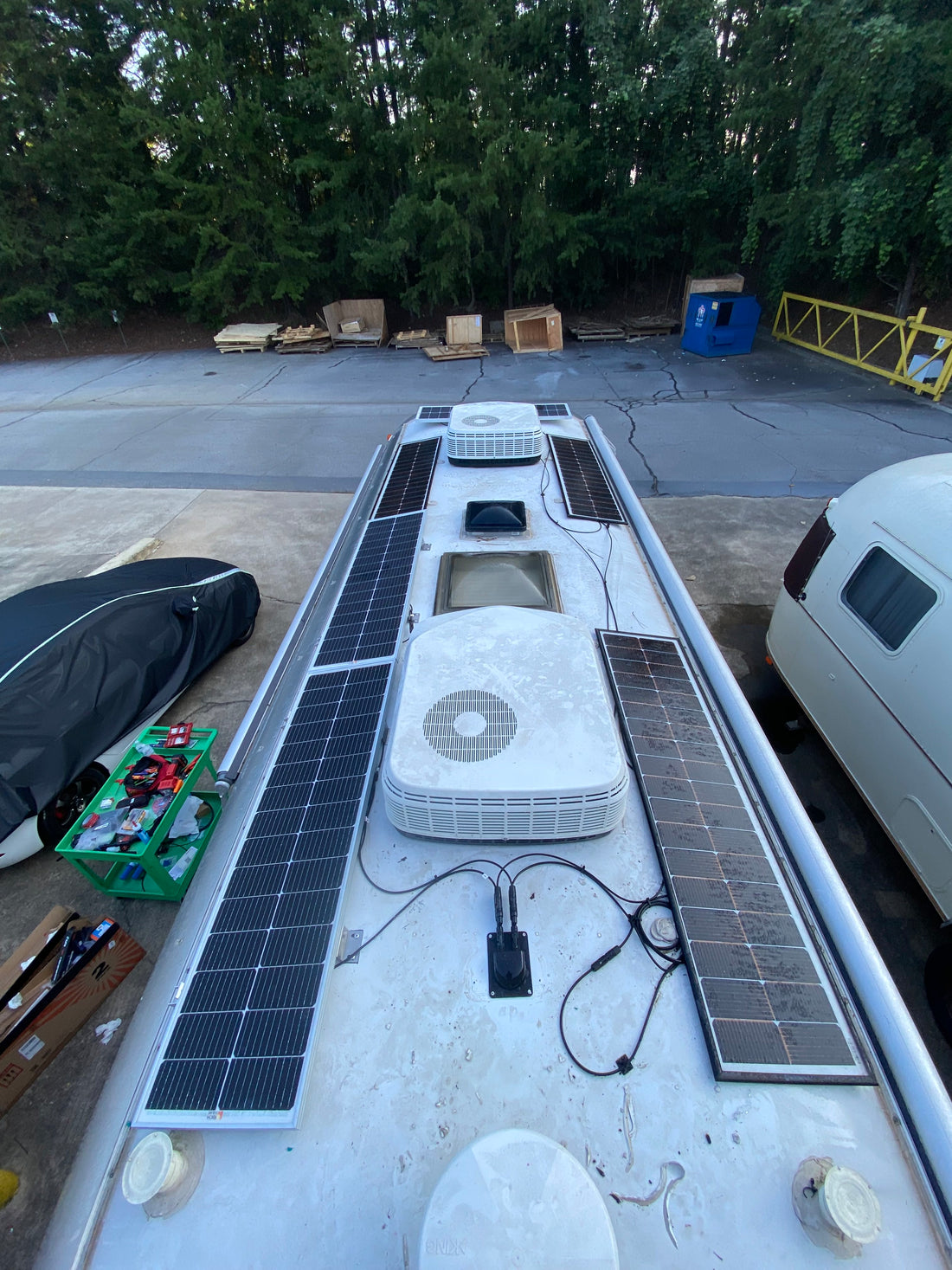 Off-grid adventure van with solar panels at sunset